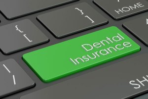 keyboard with a green dental insurance key